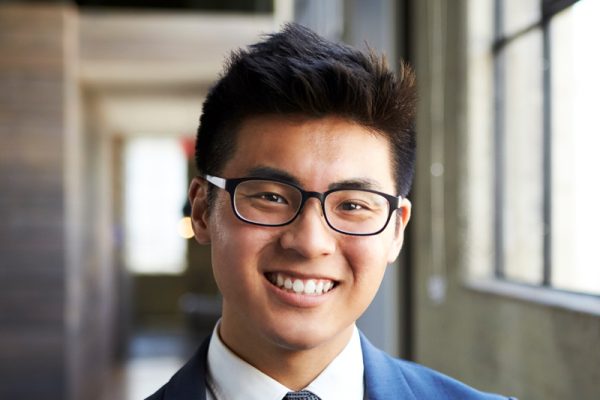 young-asian-businessman-smiling-to-camera-U7VL3Z8.jpg